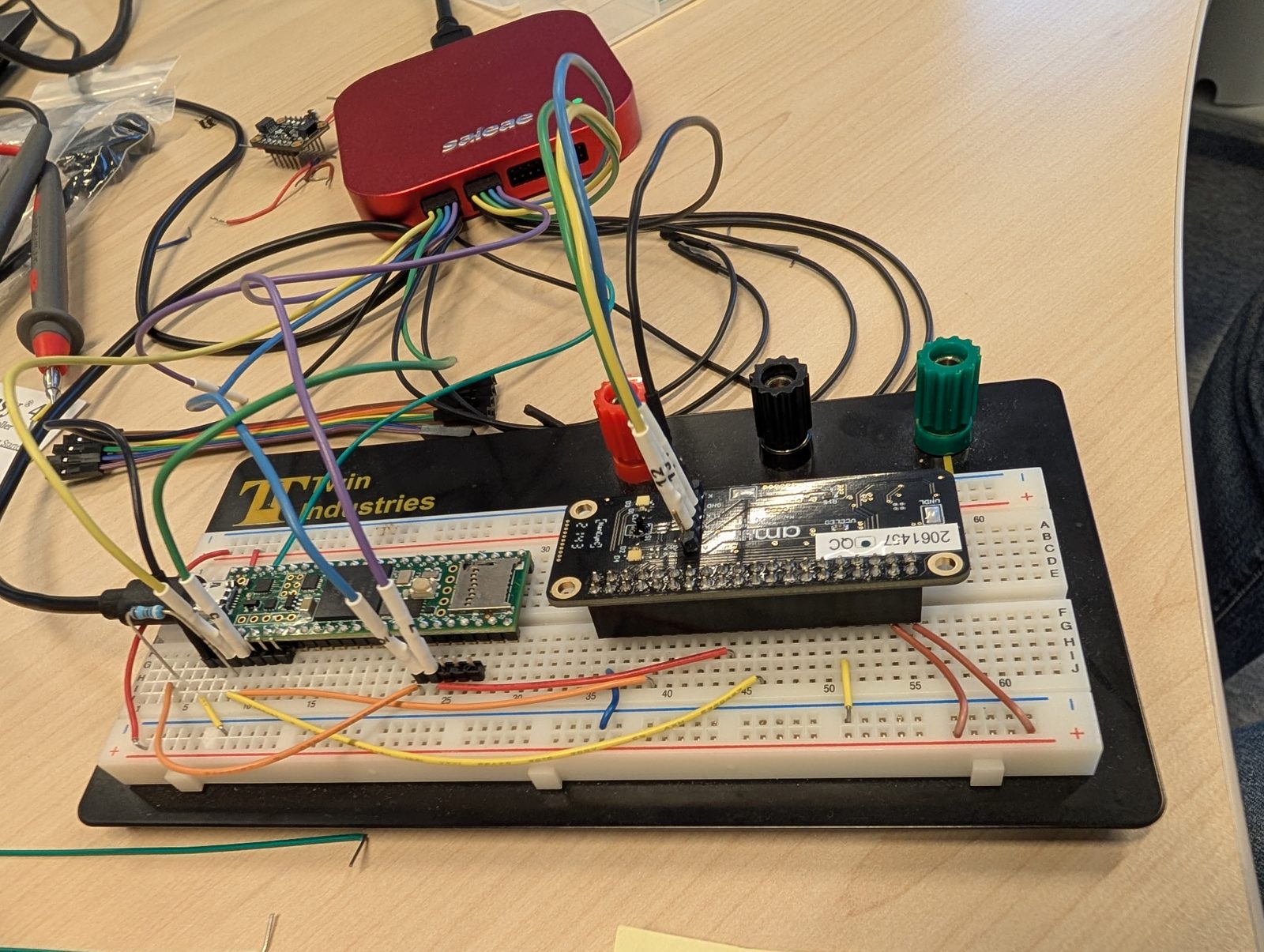 The bench setup: Teensy 4.1 on a breadboard wired to the NanoBerry board, with a Saleae logic analyser