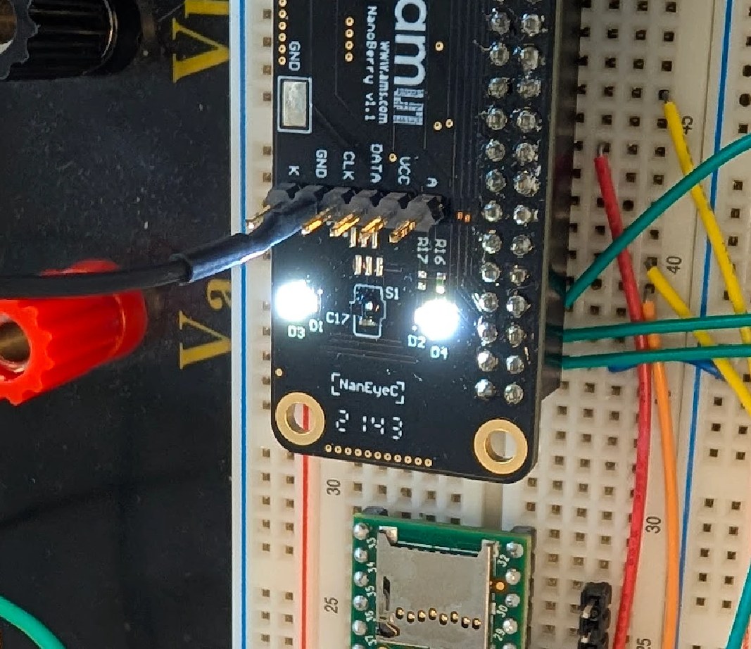 Two white LEDs lit either side of the NanEyeC sensor on the NanoBerry board